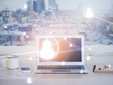 Computer on desktop with social network hologram. Multi exposure. Concept of international people connections.