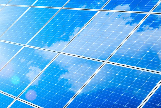 Array Of Solar Panels With Blue Sky And Sunlight Reflection- Clean Energy Concept